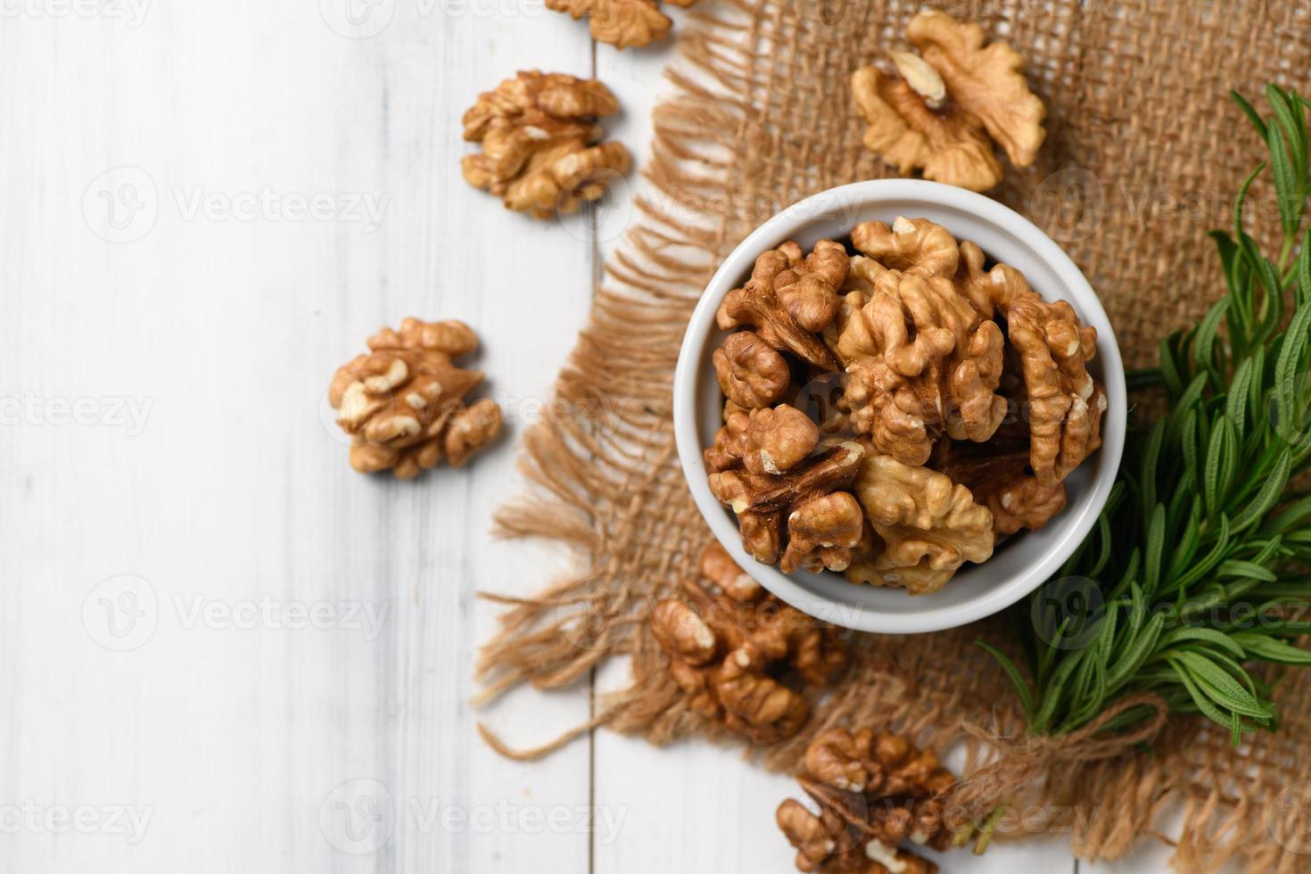 Top view of Walnut in white cup on wood background. photo