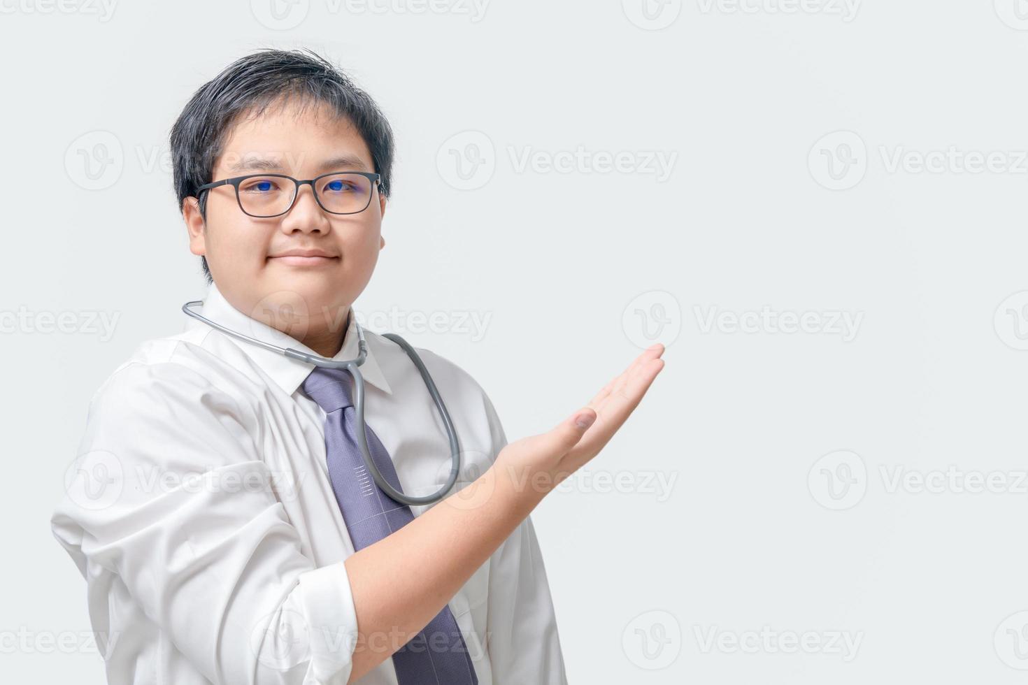 Doctor child man, medical professional holding something in empty hand isolated photo