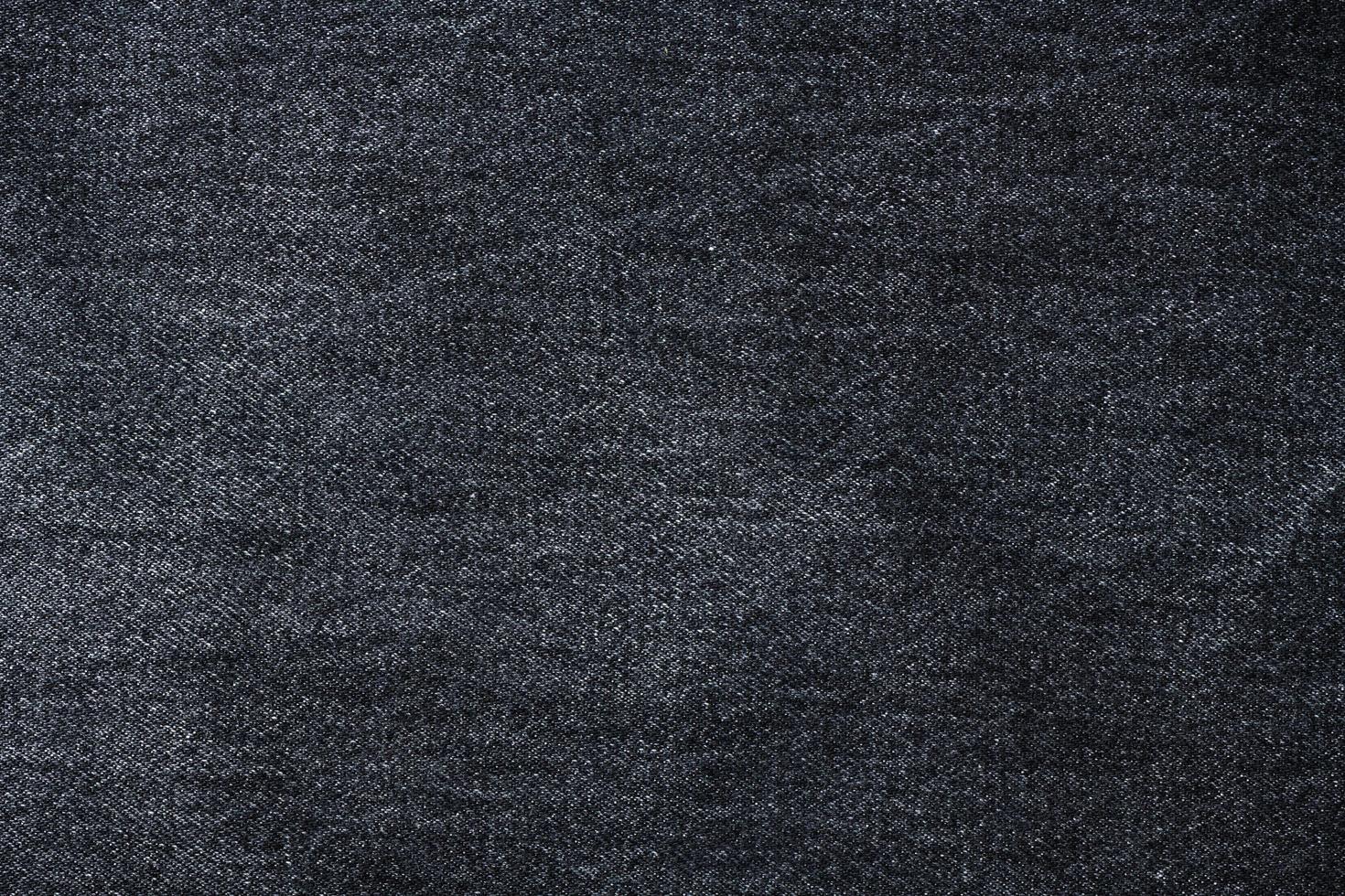 Old black jeans fabric background texture. photo