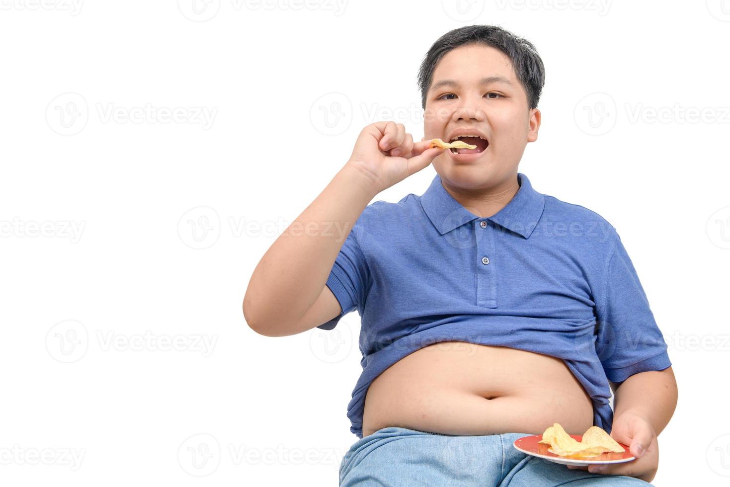 Obese fat boy eating potato chips isolated on white background, photo