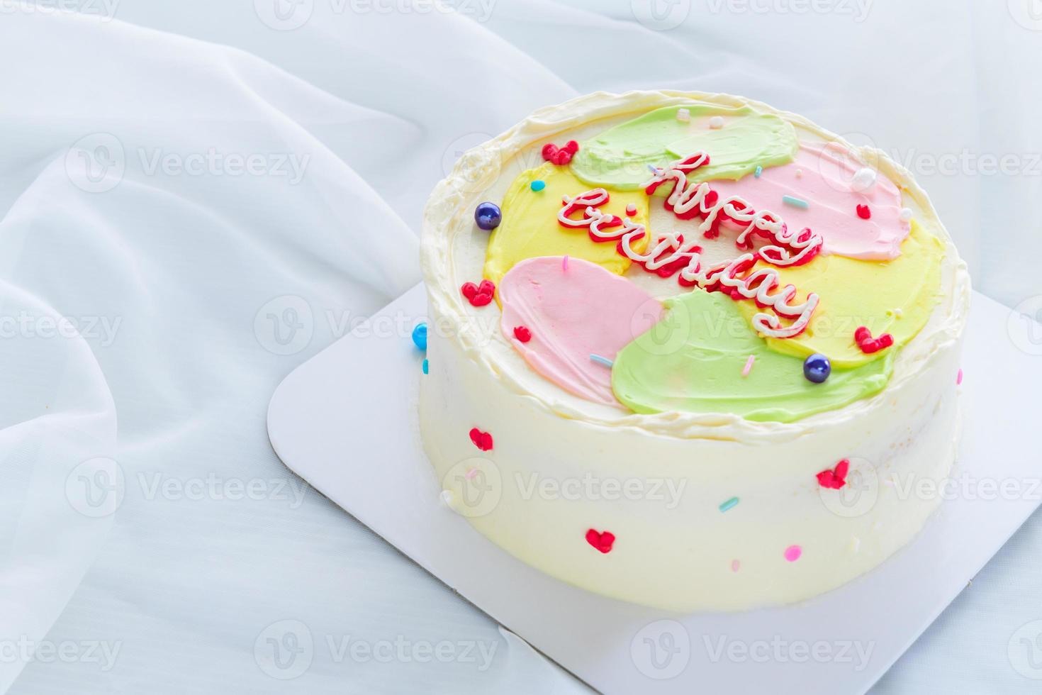 Pastel color butter cream cake on white cloth background, photo