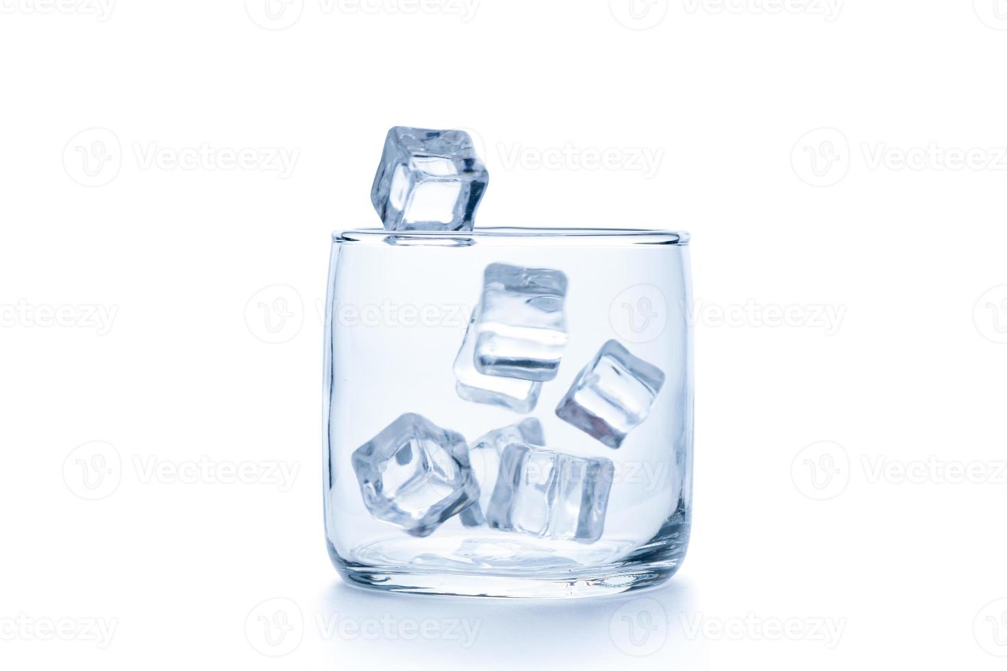 drop ice cubes in to empty Rock glass or Old Fashioned glass isolated photo