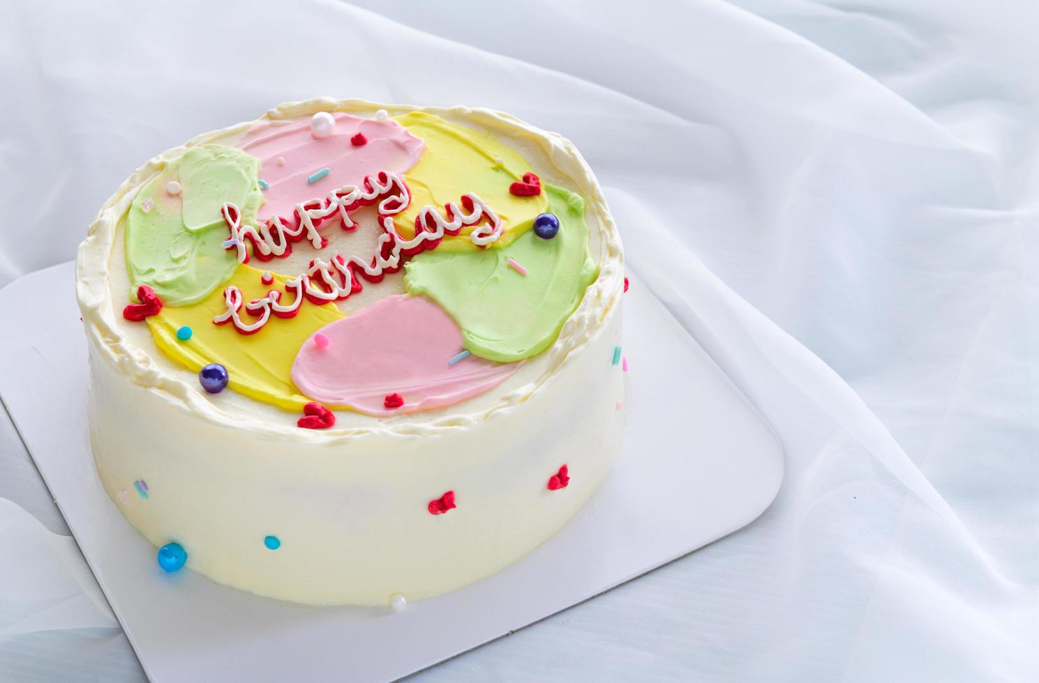 Pastel color butter cream cake on white cloth background, minimal cake concept photo