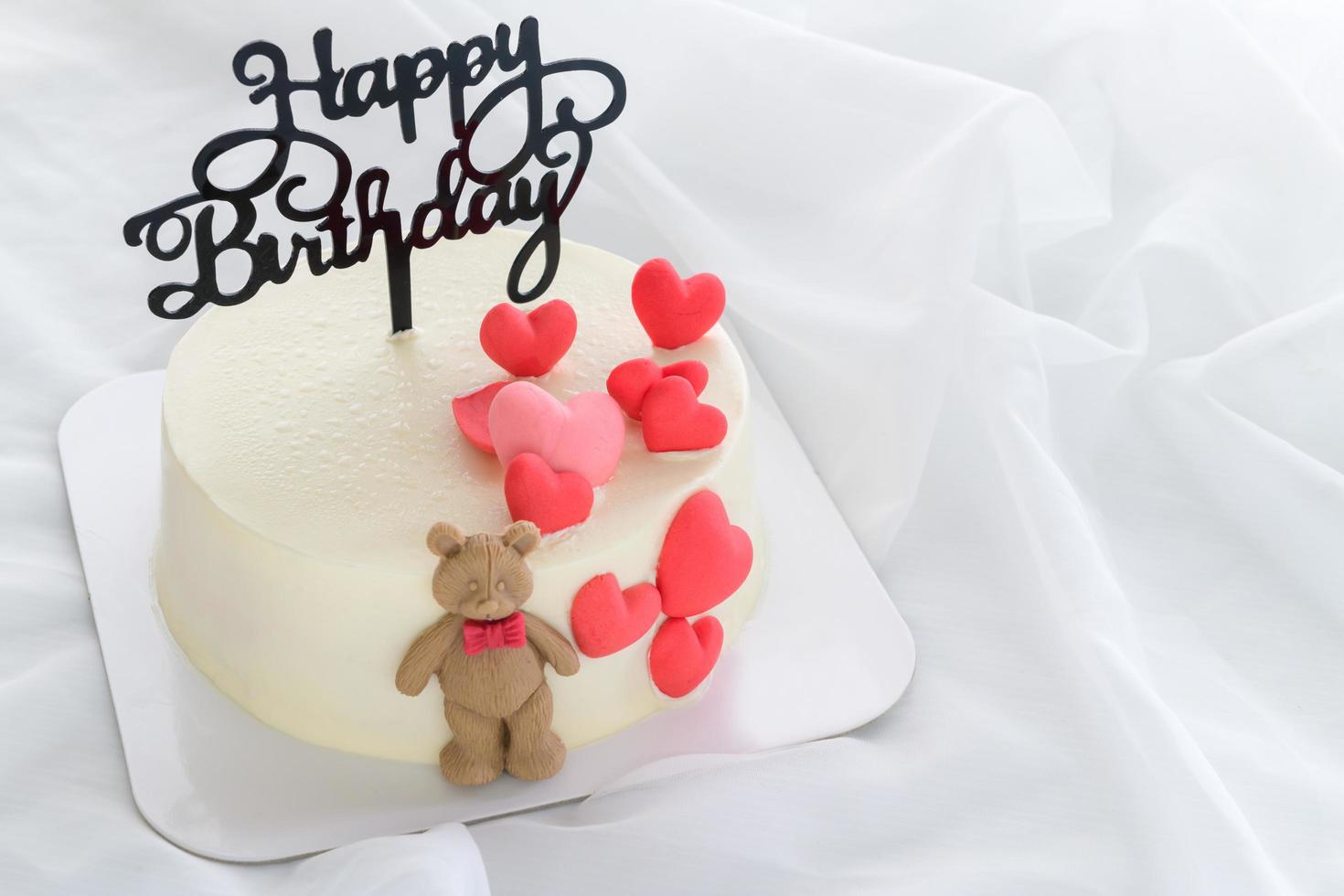 Happy Birth day Fresh butter cream cake decorated with small hearts and a teddy bear photo