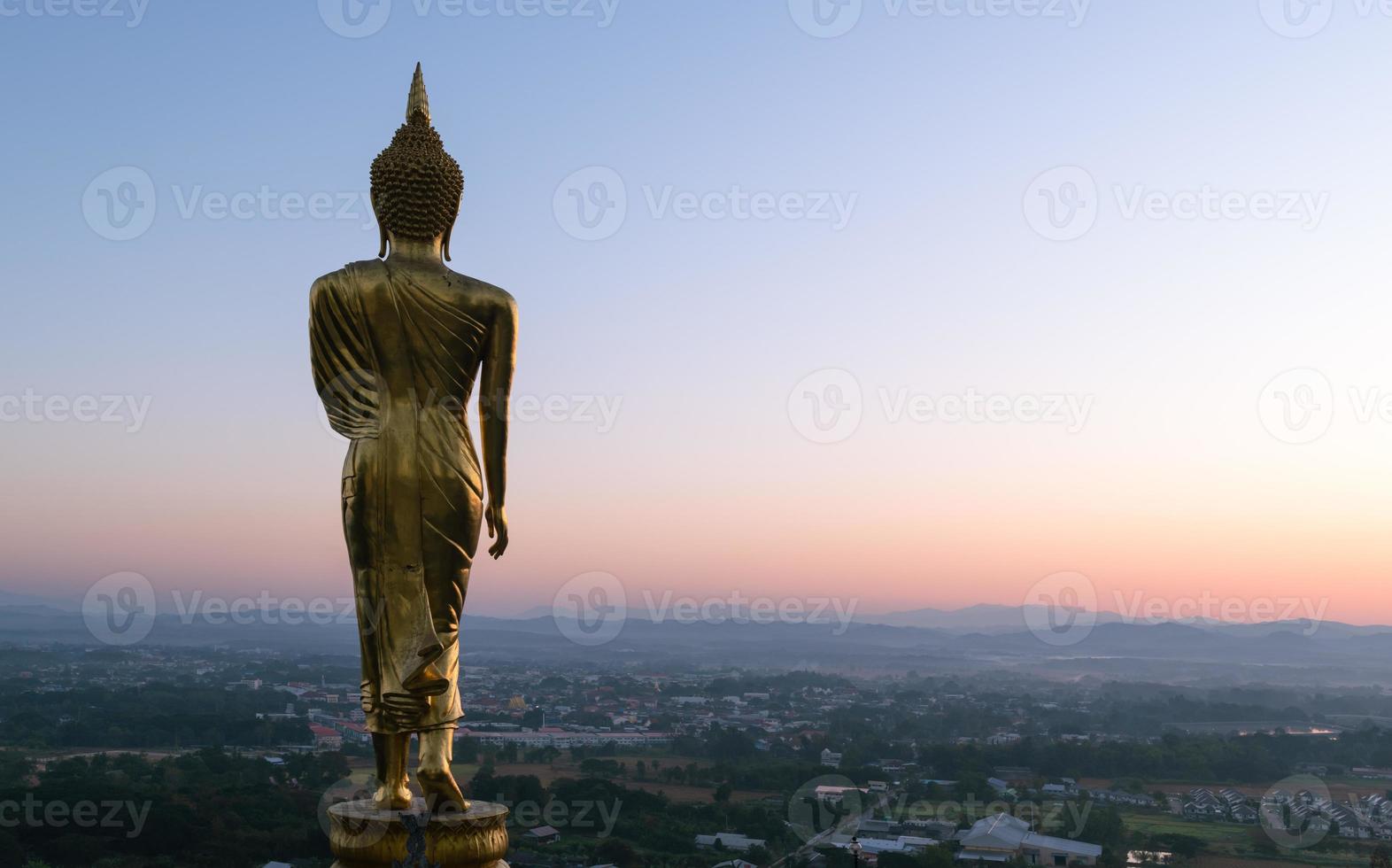 Big golden buddha statue standing in Wat Phra That Kao Noi on morning at Nan, Thailand, photo