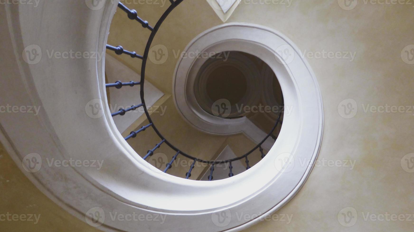 Up the stairs in a circle. Ceiling cream photo