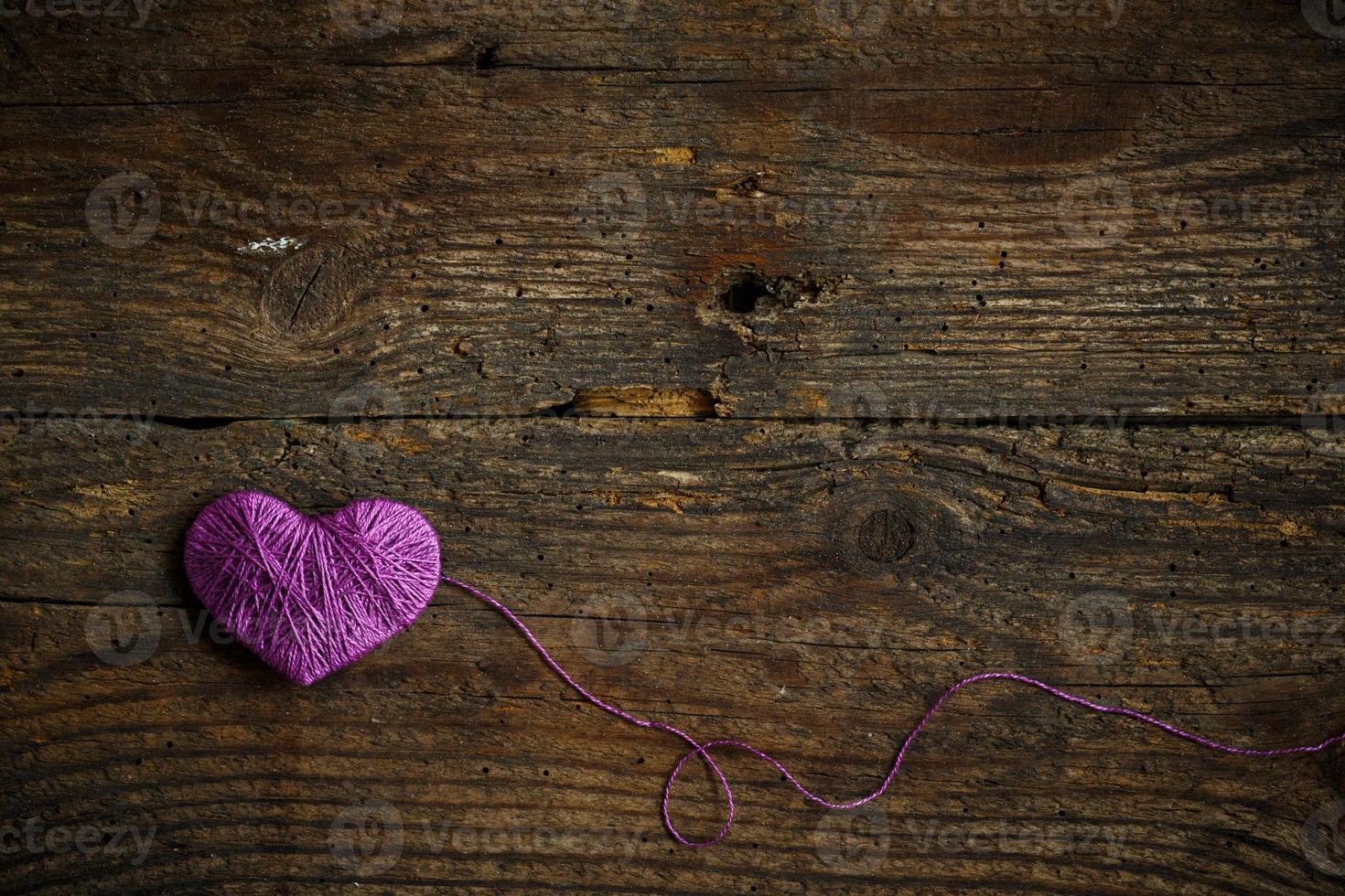 Purple Heart on on old shabby wooden background photo