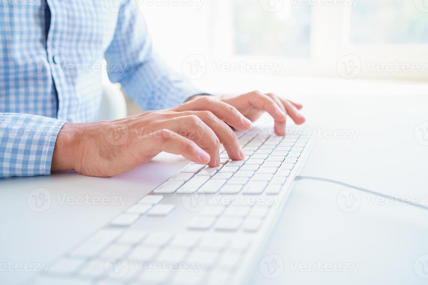 Male hands typing on the keyboard photo