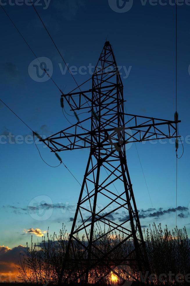 Power lines against the sky at sunset photo