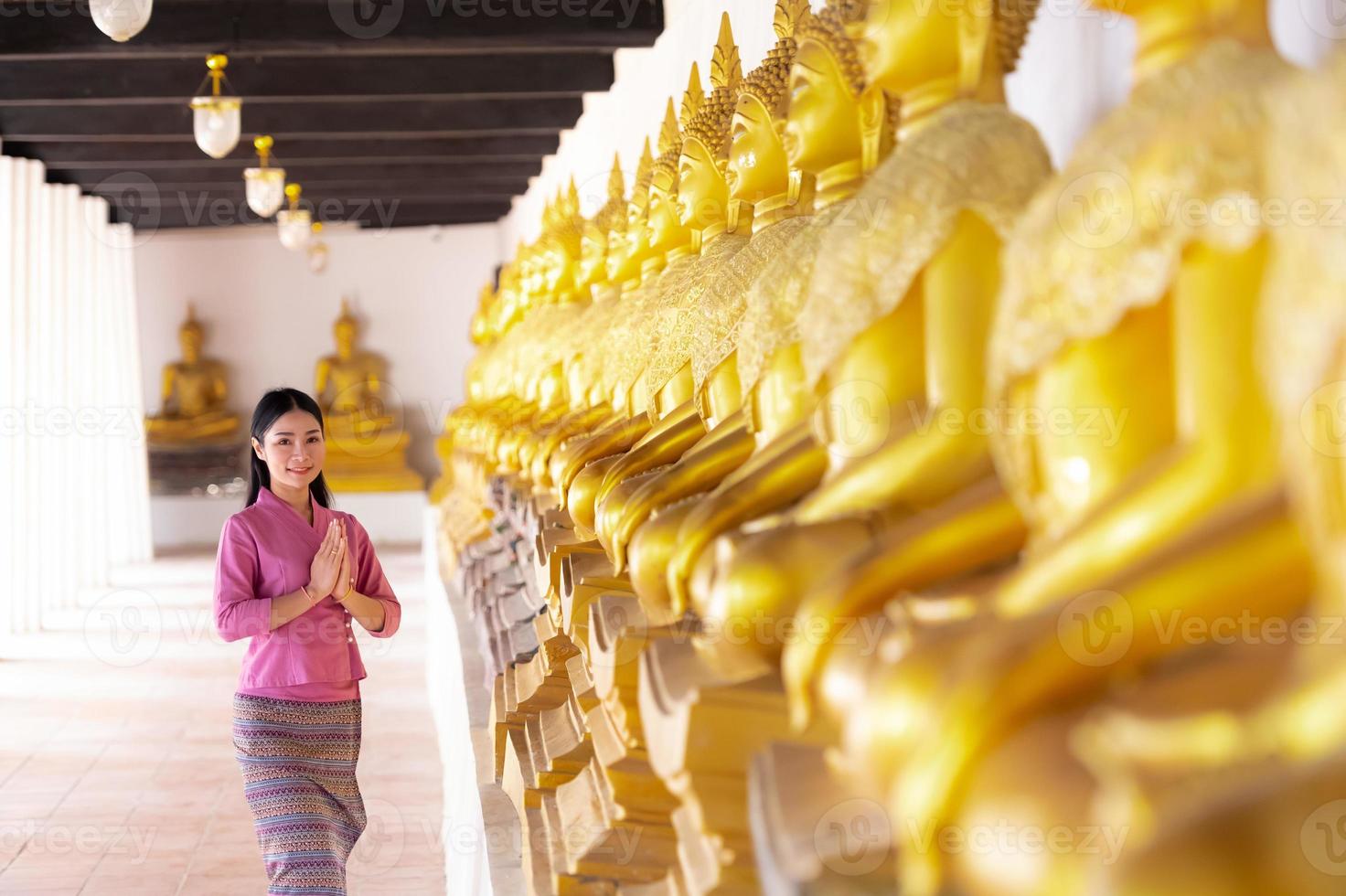 Asian woman to paying respect to Buddha statue in Ayutthaya, Thailand. photo