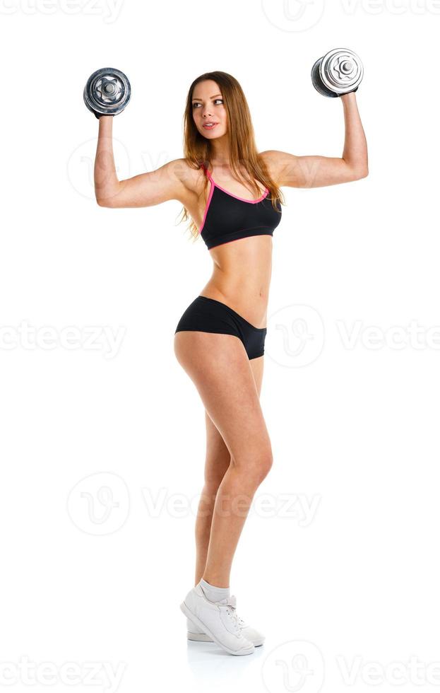 Beautiful sport woman with dumbbells doing sport exercise, isolated on white photo