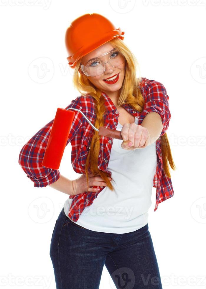 Funny girl in a helmet with roller in hand it is isolated on the white photo