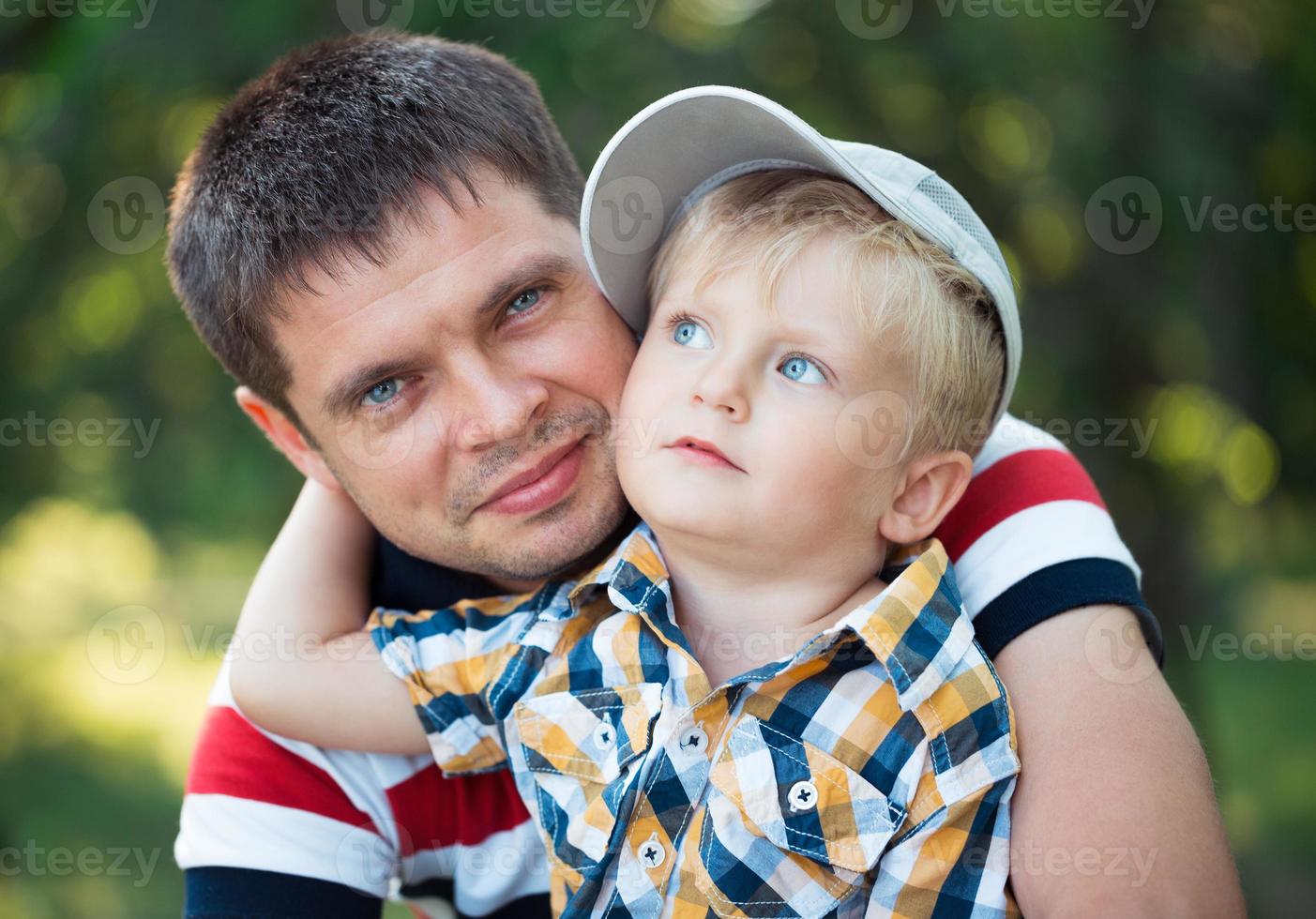 Father and his baby son having fun in the park outdoor photo