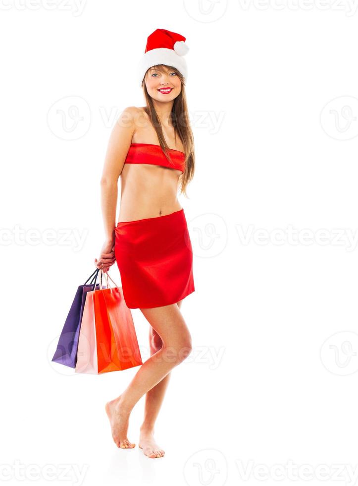 Beautiful Santa christmas girl with shopping bags on white photo