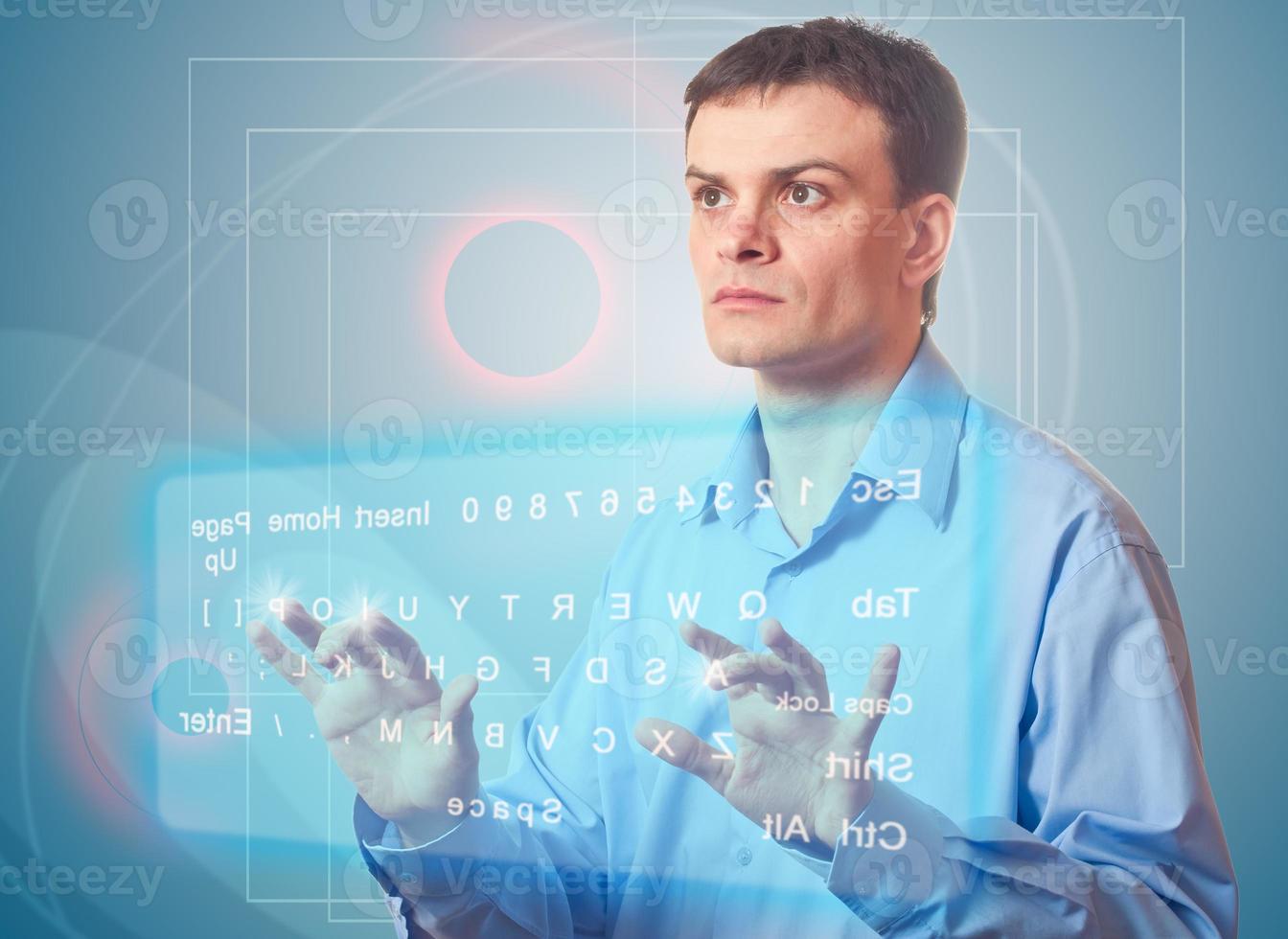 Young Men and Two Virtual Keyboard. photo