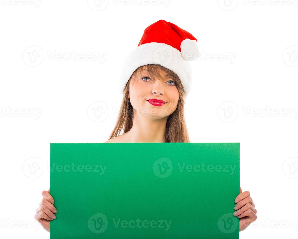 Smiling christmas girl with green placard on white photo