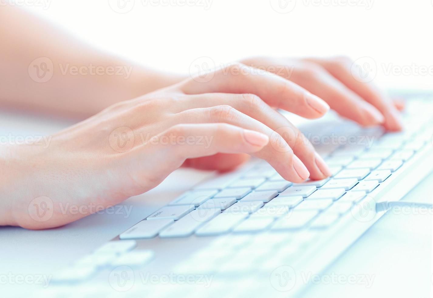 Female hands or woman office worker typing on the keyboard photo