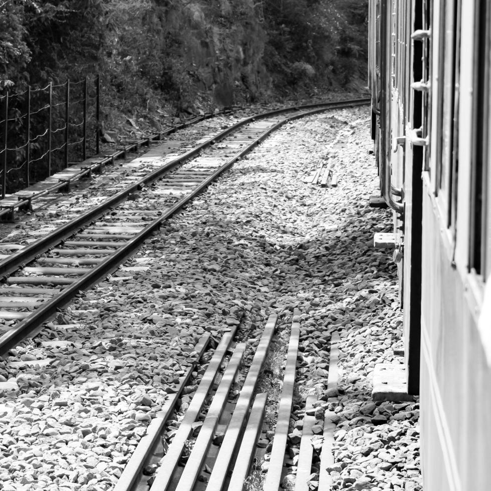Toy Train moving on mountain slopes, beautiful view, one side mountain, one side valley moving on railway to the hill, among green natural forest. Toy train from Kalka to Shimla in India, Indian Train photo