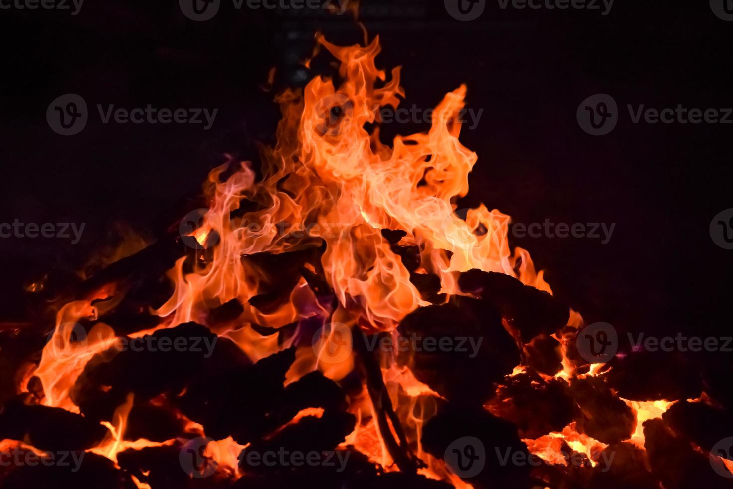 Fire flames on black background, Blaze fire flame texture background, Beautifully, the fire is burning, Fire flames with wood and cow dung bonfire photo