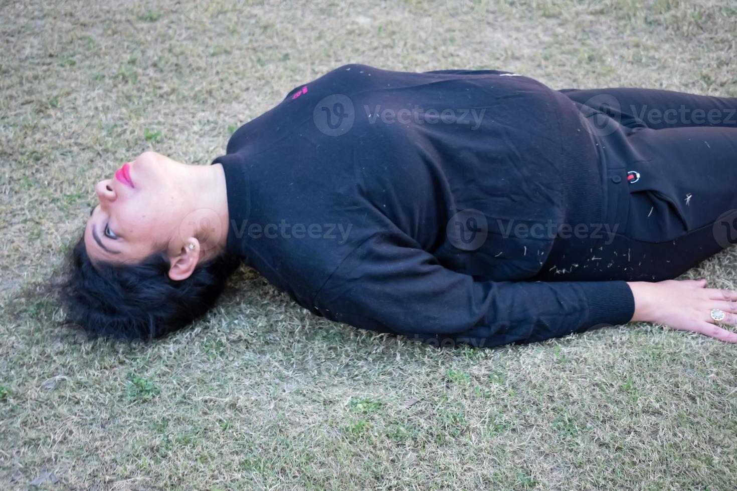 Young Indian woman practicing yoga outdoor in a park. Beautiful girl practice basic yoga pose. Calmness and relax, female happiness. Basic Yoga poses outdoor photo