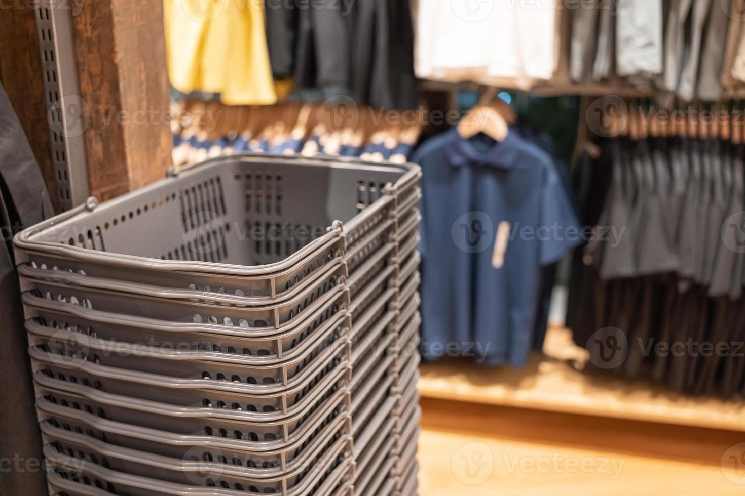 stacked shopping basket in shirt store on vintage backgrounds. Shopping Basket Blur Interior Shop shelf background Retail business concept. photo