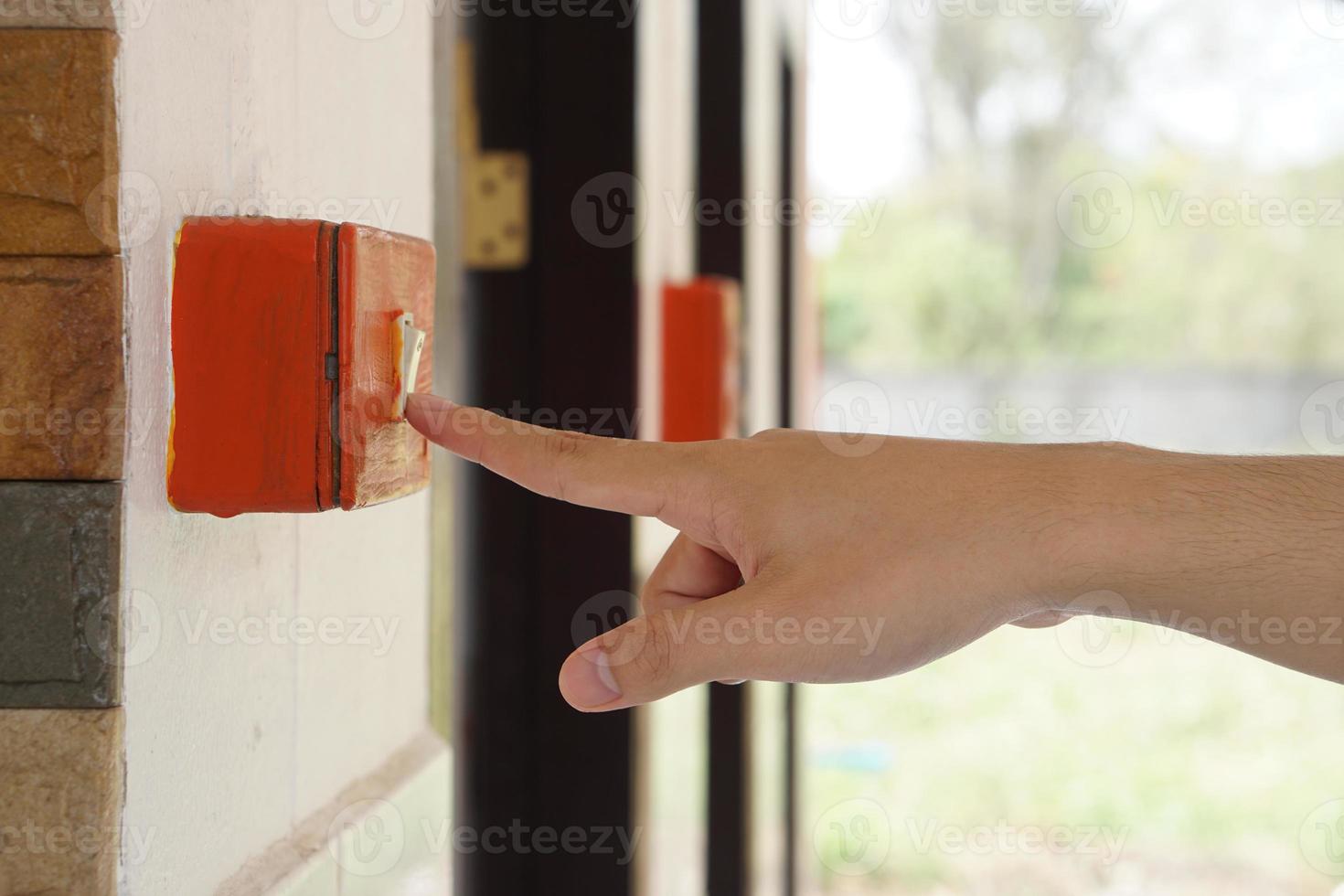 Closeup hand is press electric switch to switch off the light after using. Concept, campaign to save electricity energy. Stop global warming. photo