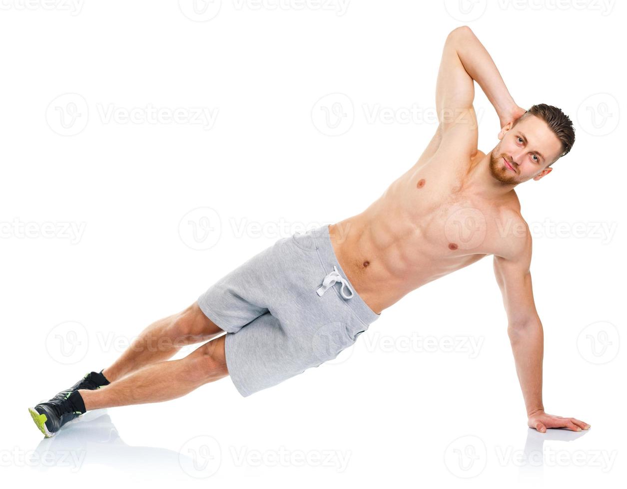 Sport attractive man doing fitness exercises on the white photo