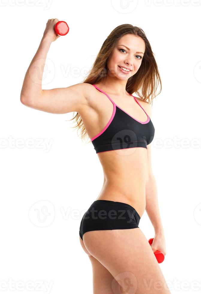 Happy athletic woman with dumbbells doing sport exercise, isolated on white photo