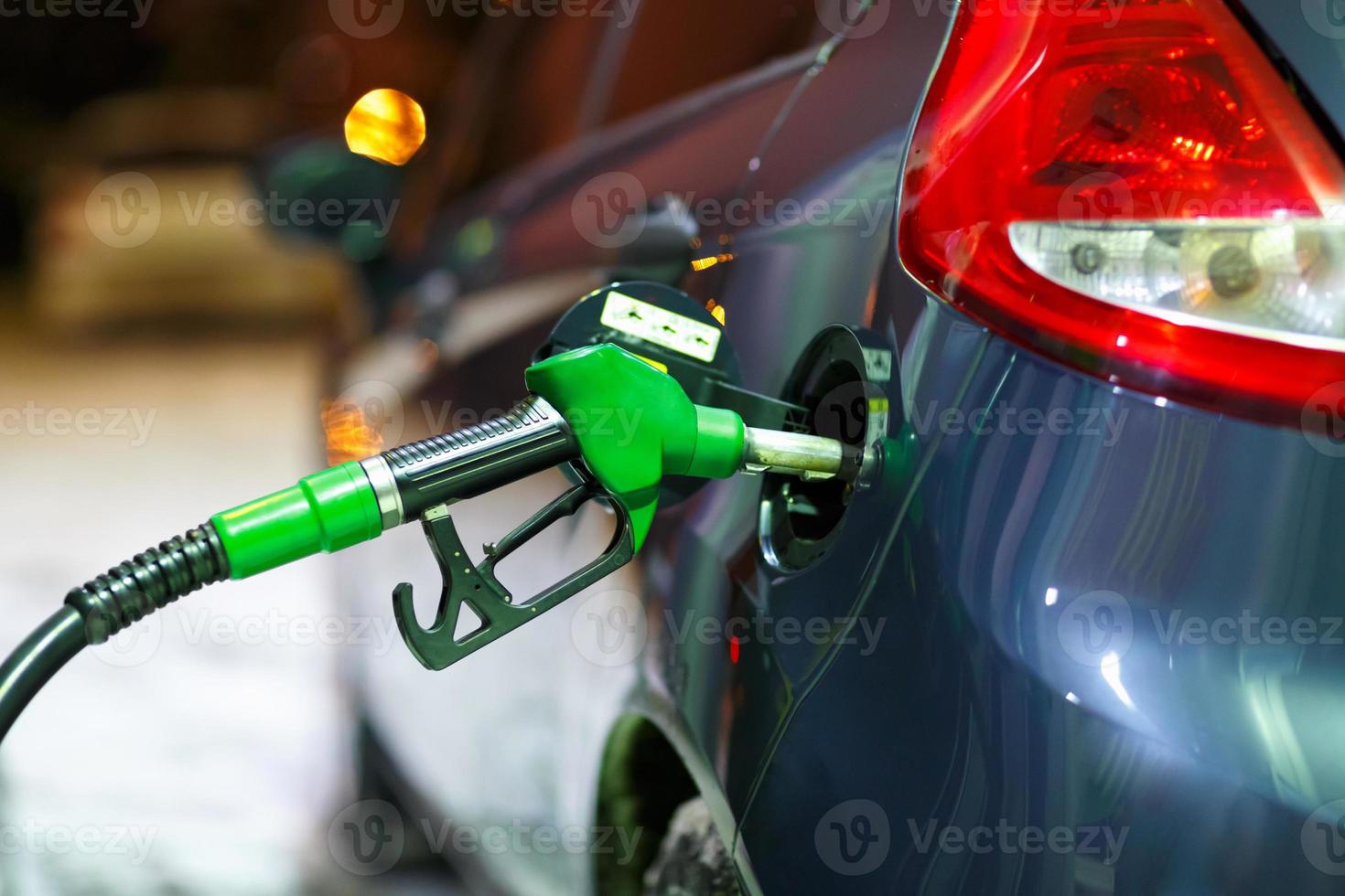 Car refueling on a petrol station in winter at night photo