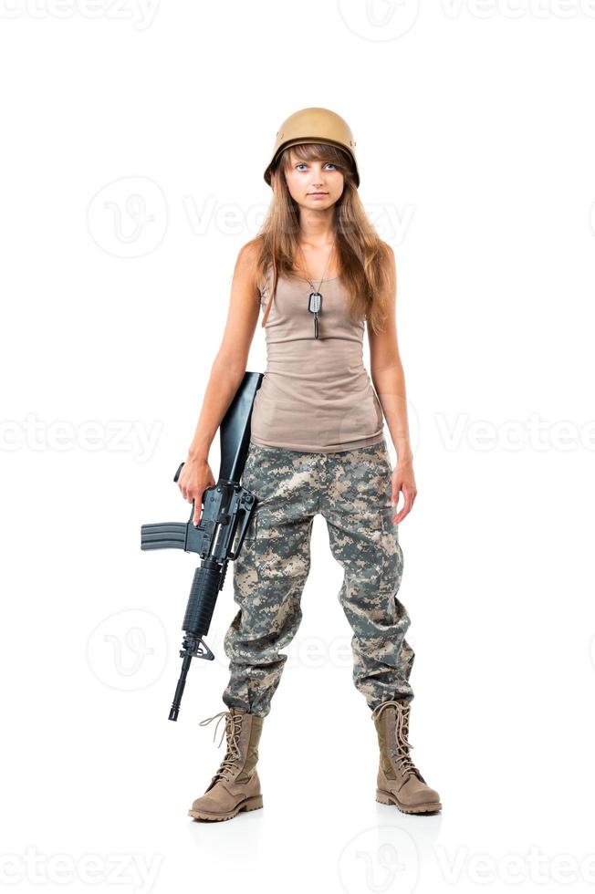 Soldier young beautiful girl dressed in a camouflage with a gun in his hand on white photo