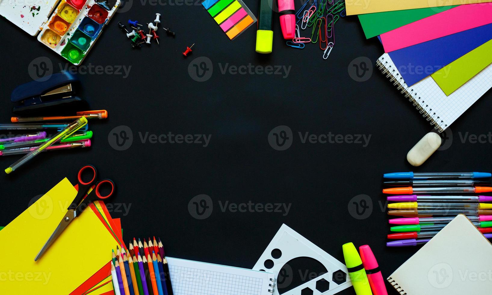 School supplies on blackboard background ready for your design photo