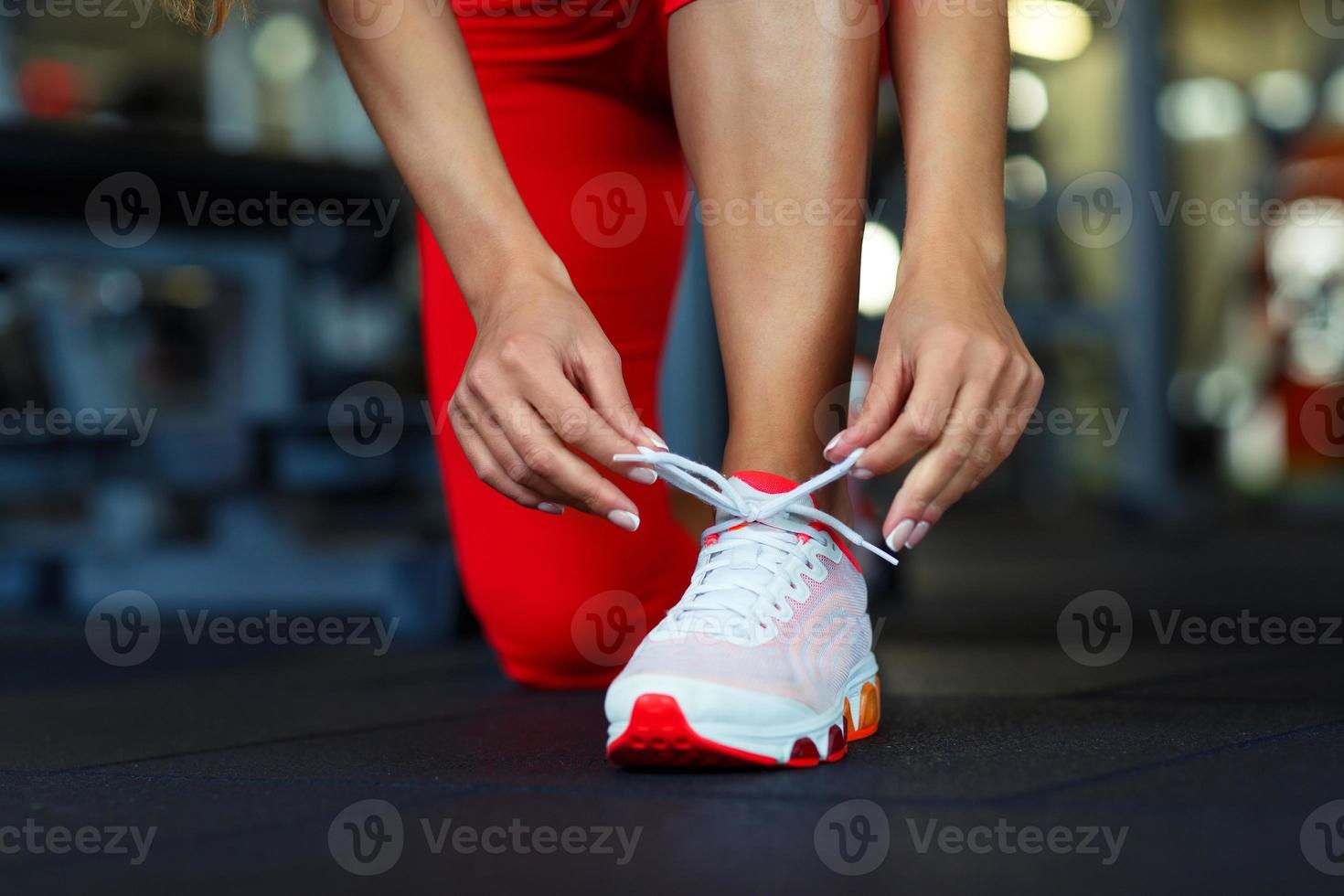 Running shoes - woman tying shoe laces photo