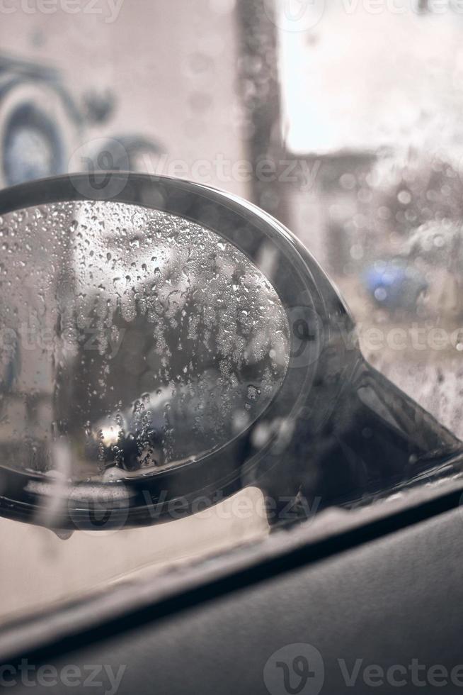 Hand wash with soap, pink foam on the body. Car washing with high pressure water. photo