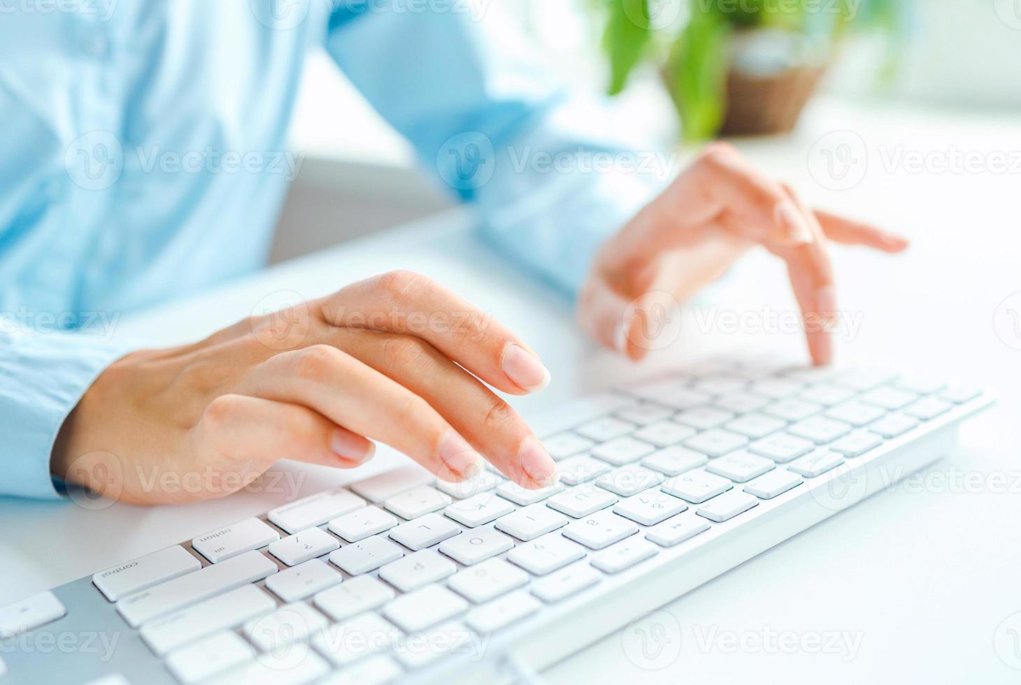 Woman office worker typing on the keyboard photo