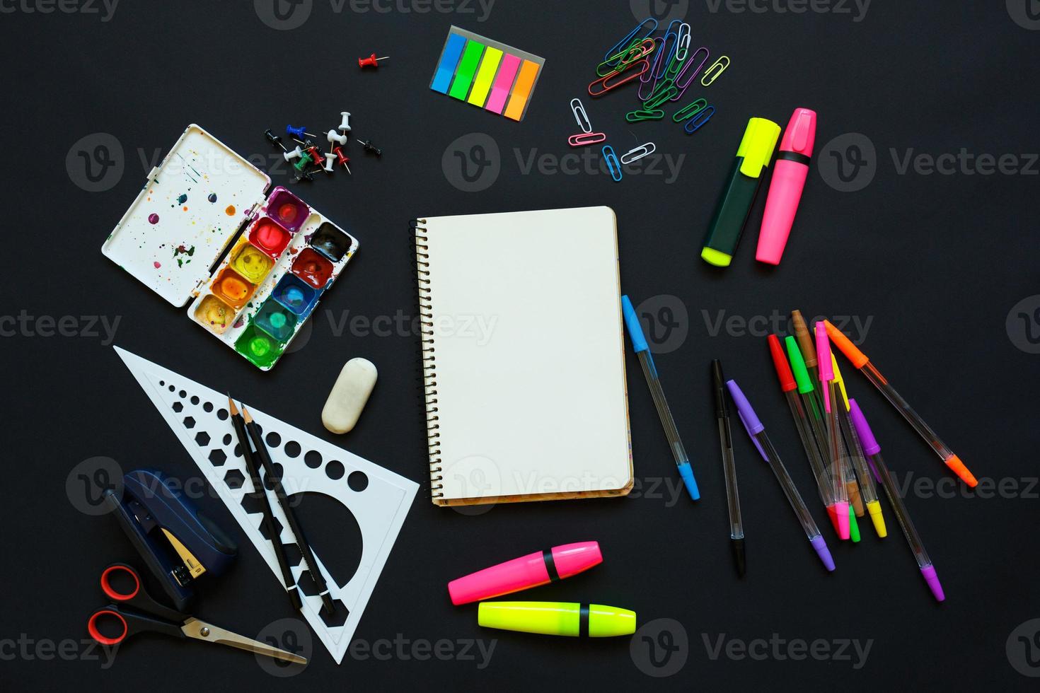 School supplies on blackboard background photo