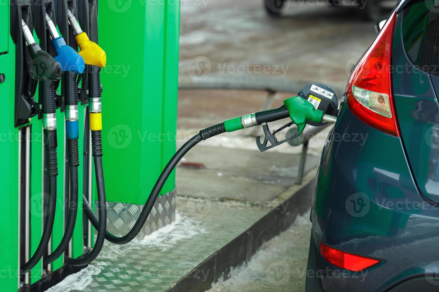 Car refueling on a petrol station in winter photo