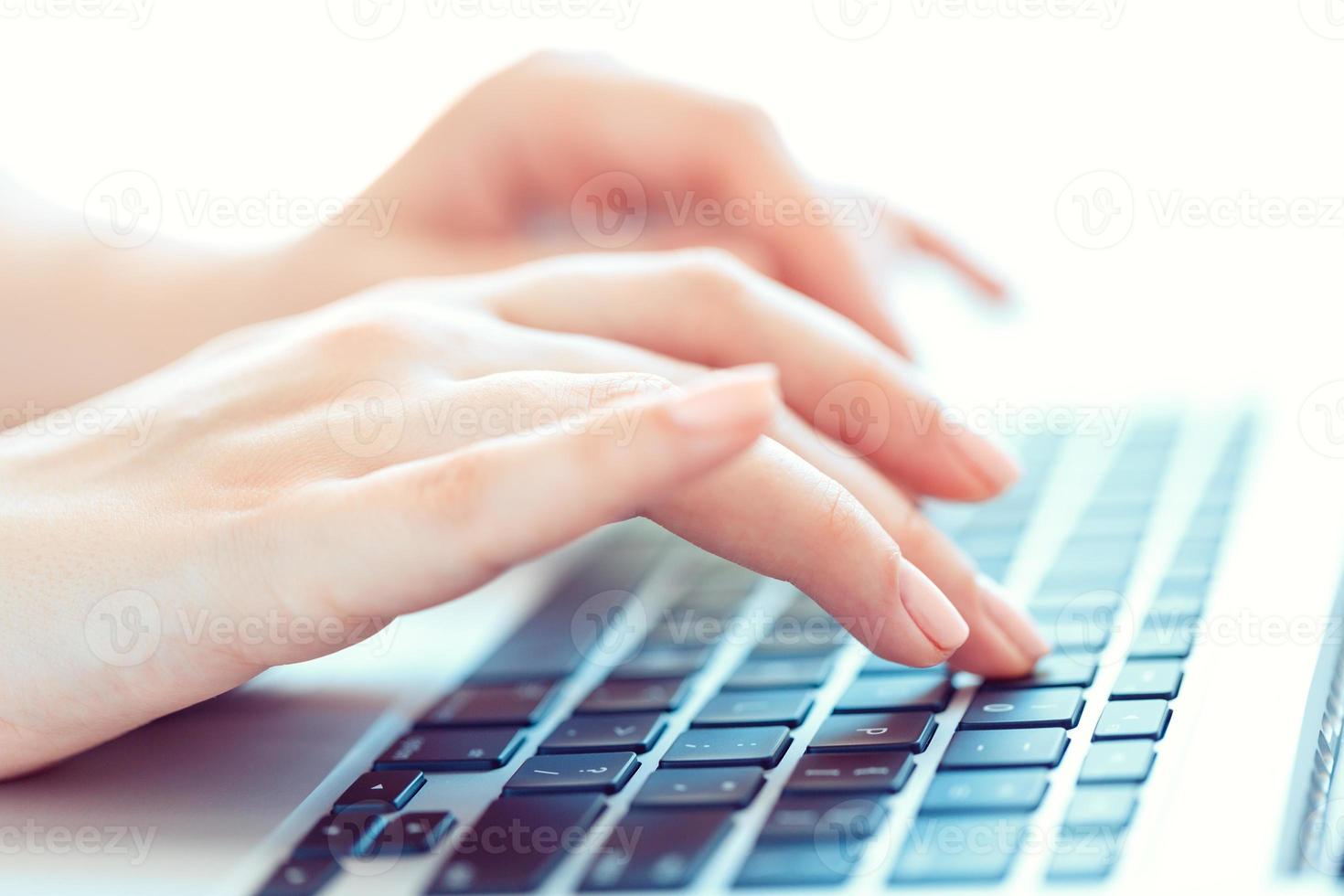 Female hands or woman office worker typing on the keyboard photo