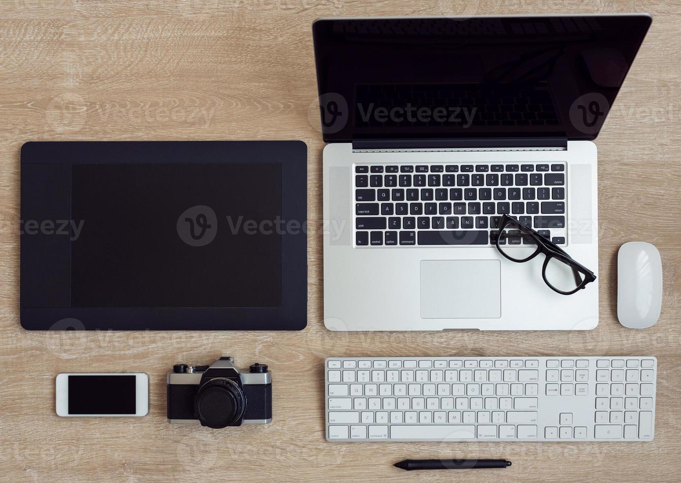 Business workplace with laptop and gadgets on wooden background photo