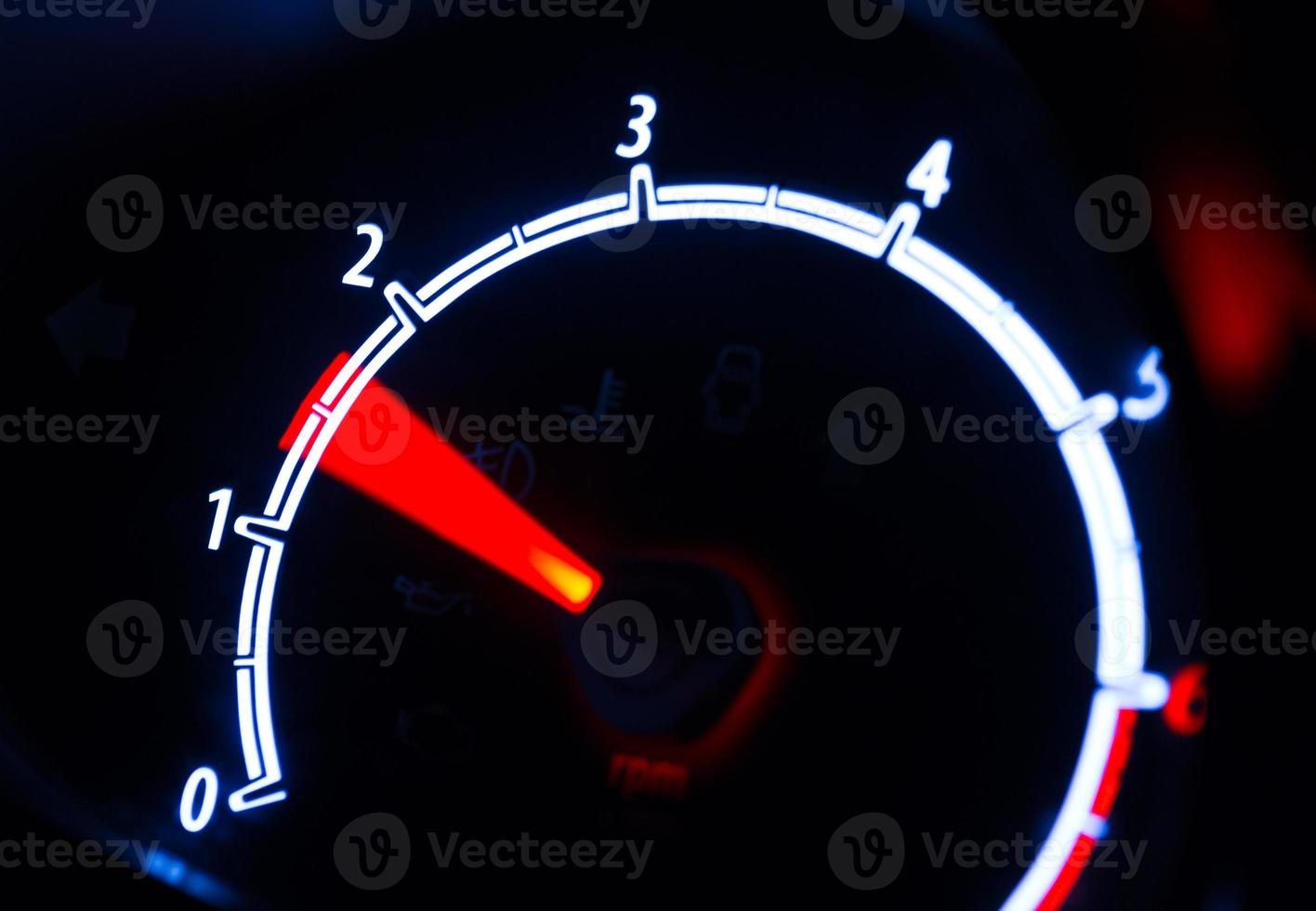 Tachometer illuminated at night photo