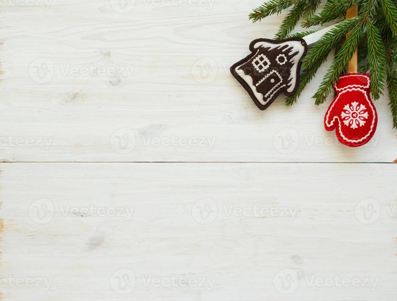 Christmas tree branches with christmas decorations on white wooden texture ready for your design photo