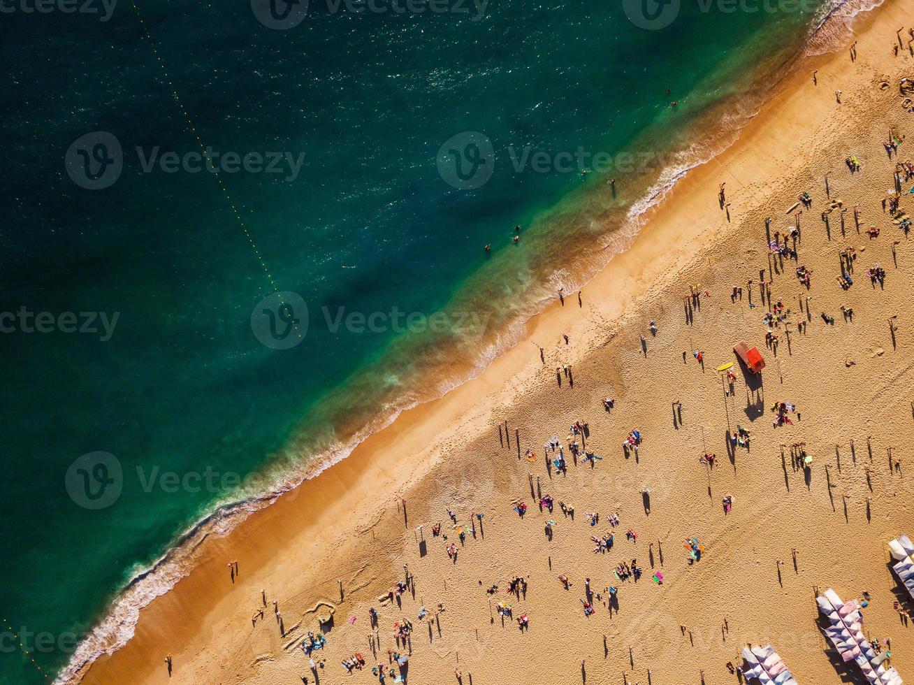 View from above to a busy beach. Coast of the Atlantic Ocean photo