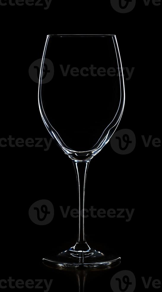 Empty white wine glass on a black photo