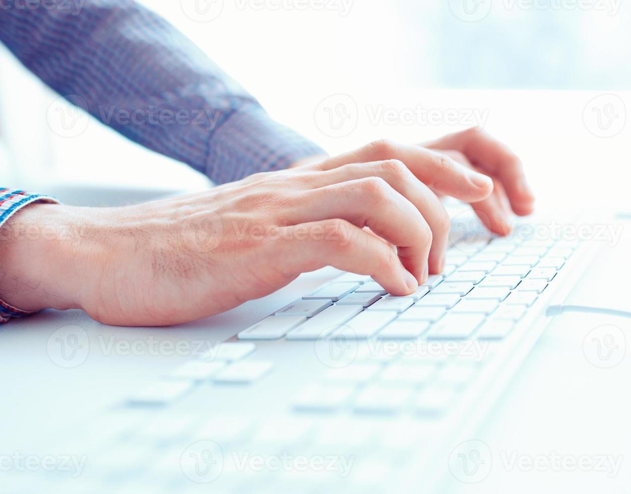 Male hands or men office worker typing on the keyboard photo