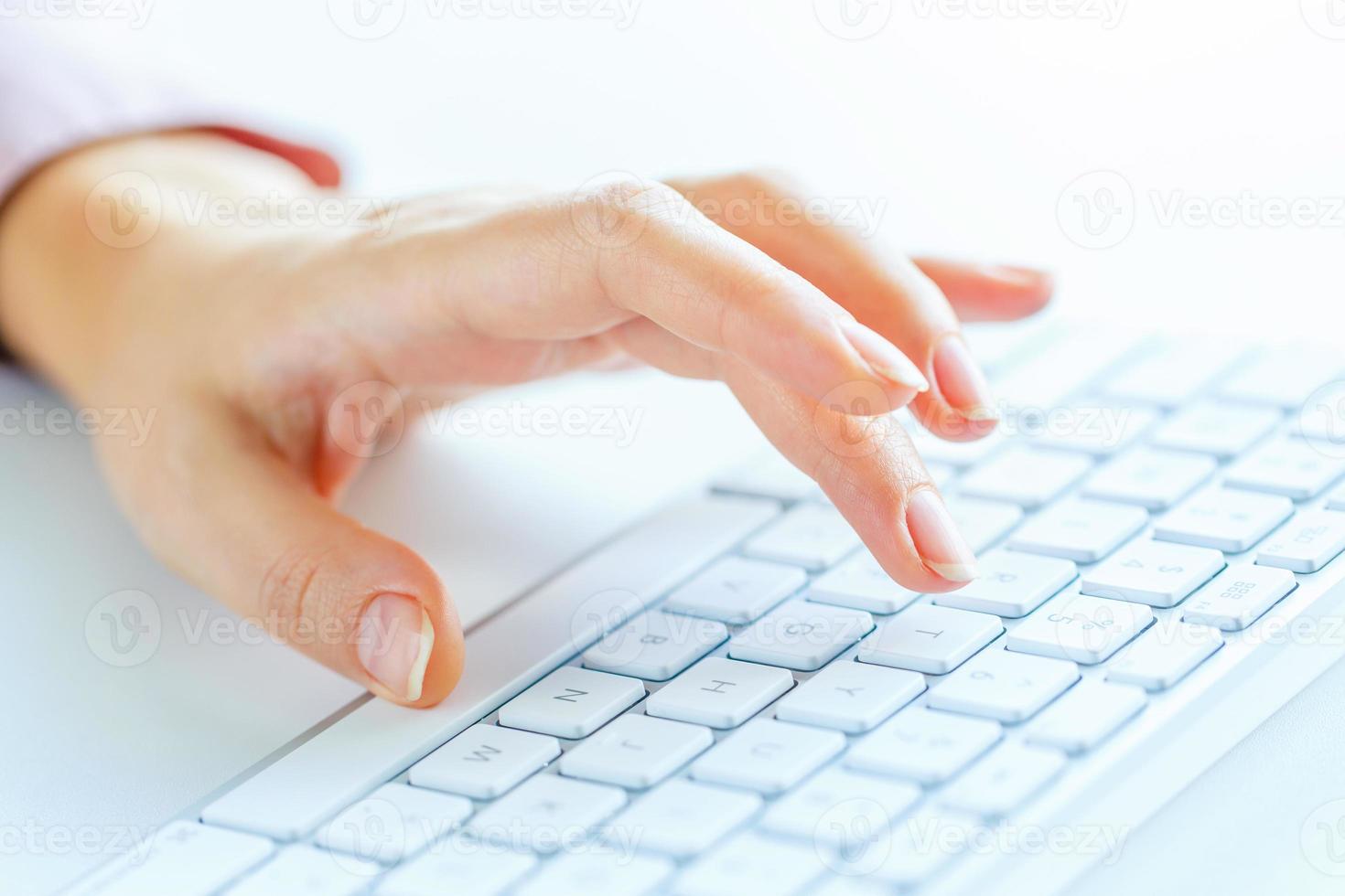 Woman office worker typing on the keyboard photo