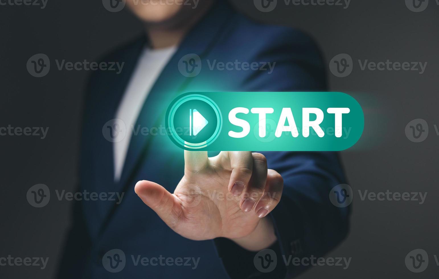 Businessman touch on virtual screen start button for business concept of new start, business planning, strategies and challenges or career paths, opportunities, and changes. photo