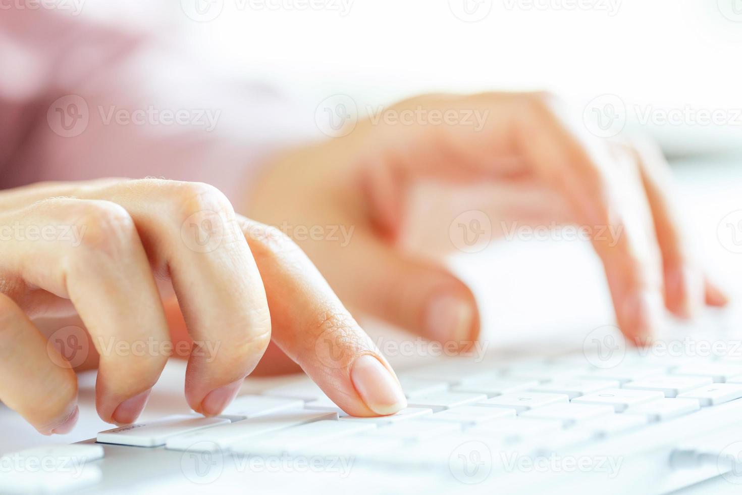 Woman office worker typing on the keyboard photo