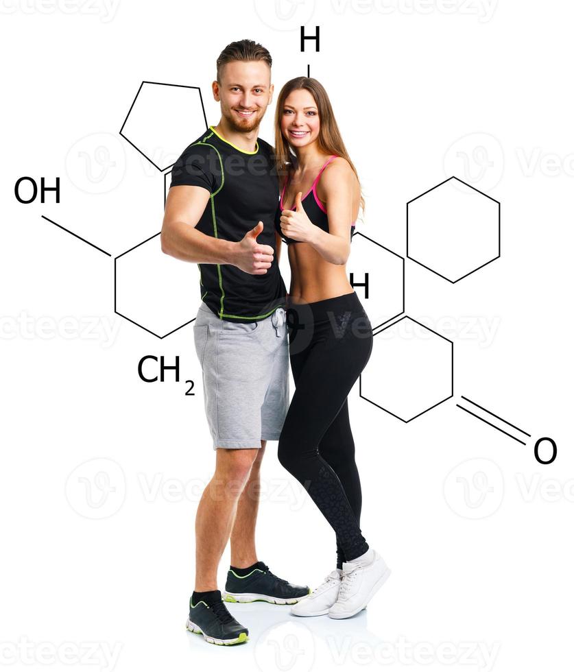 Athletic man and woman after fitness exercise with a finger up on the white with the chemical formula on background photo