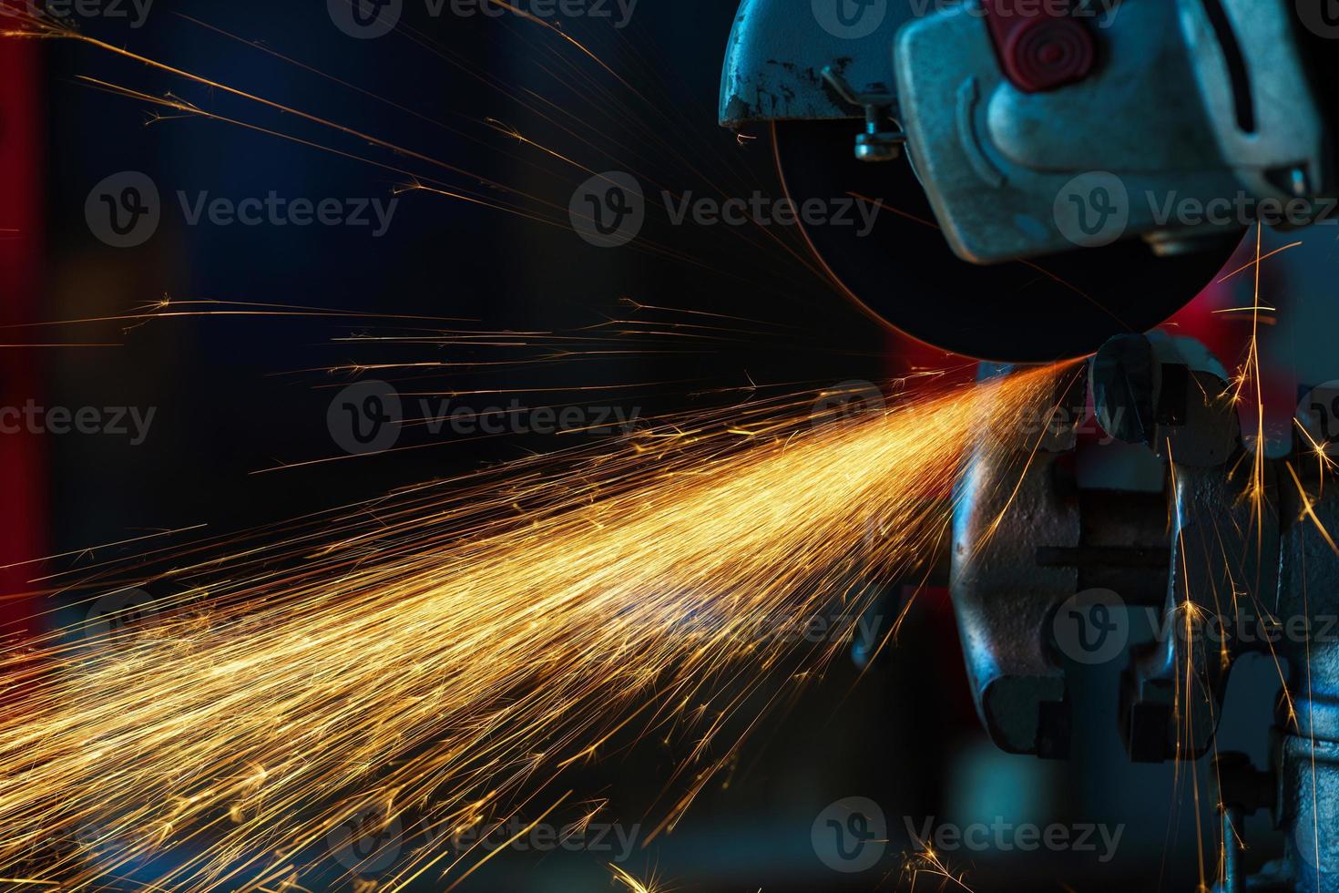 Angular grinding machine is cutting the metal and a lot of sparks photo