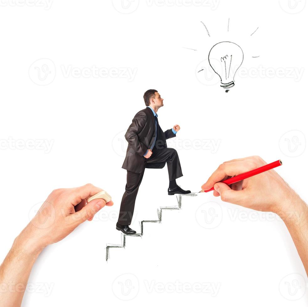 Hand draws stairs with walking businessman on white photo