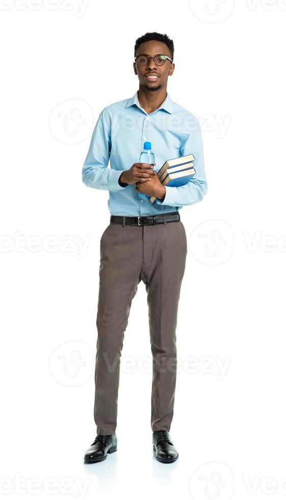 Happy african american college student with books and bottle of water in his hands photo